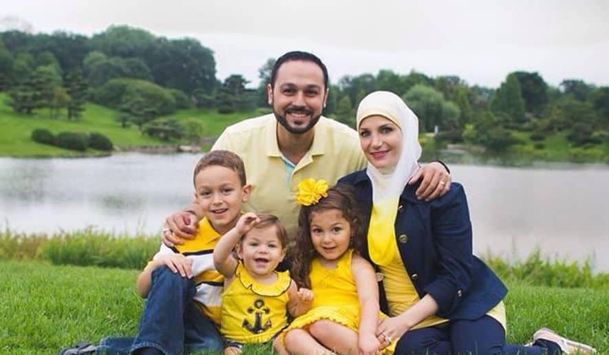 Family sitting together in a park setting.